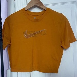 Orange nike shirt.